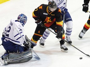 Belleville Bulls forward Michael Curtis is stopped by Mississauga Steelheads goalie and former Bull, Tyson Teichmann, during OHL playoff action Saturday night at Yardmen Arena. (Jerome Lessard/The Intelligencer)
