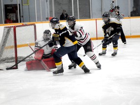 Diana Rinne/Daily Herald-Tribune
Grande Prairie Sherpa Safety Midget AA Storm captain Kevin Henley races Calgary Blackhawks player Mackenzie Riviore for the loose puck in during a game at the provincial Major Midget AA tournament in Whitecourt, Saturday. The Storm lost 8-6.