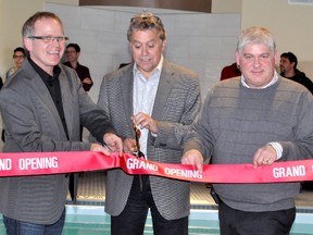 Marc L. Staniloff, president and chief executive of Superior Lodging Corp., snips the ribbon during the official opening of the Microtel Inn & Suites by Wyndham in Timmins on Thursday, as two of the new hotel’s principal owners, Luc Sergerie, left, and Gilbert Mondoux hold the ribbon. A large crowd gathered in the indoor pool area to help mark the opening of one of Timmins’ newest hotels.