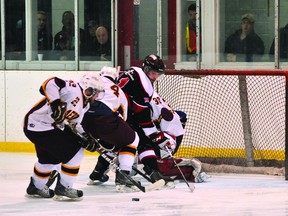 Athens Aeros forward David Empey swoops in to clear a loose puck from the team's goalmouth during game four of the Rideau-St. Lawrence Conference final Sunday night at Centre 76. (ALANAH DUFFY The Recorder and Times)