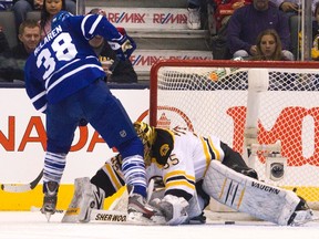 Maple Leafs' Frazer McLaren (L) scores on Boston Bruins goalie Anton Khudobin as the puck trickles between his legson Saturday. (REUTERS/Fred Thornhill)