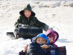 Evertte Twiss, 8, Alysha Lahowich, 5, and Taylor McNab, 6, toboggan down the hill at Tupper Street Bridge on Sunday. The warm weather made it a great day for sledding. (Svjetlana Mlinarevic/Portage Daily Graphic)