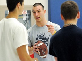 Windsor Lancers quarterback Austin Kennedy, centre, gives instructions during a football clinic Sunday at Chatham-Kent Secondary School. (MARK MALONE/The Daily News)