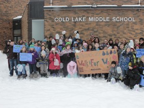 Students and teachers of CLMS gather with their handmade poster to celebrate both their having raised enough money for a well in India and the inaugural “Walk for Water” marathon -- A one kilometre walk with jugs of water filled to simulate those forced to search for water in developing countries.