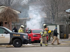 Brant firefighters extinguish a car fire at a residence on Telfer Court in Paris on Monday, March 25 shortly after 1 p.m. with the assistance of OPP officers and area residents. The fire was under control before it could engulf the vehicle. Flames could be scene pouring out of the bottom of the car. MICHAEL PEELING/The Paris Star/QMI Agency