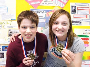 Cody Williams, 12, and Sarah Thomson, 13, hold up their first place medals for the Grade 5/6 and 7/8 categories, respectively, for their win on March 20 for Portage la Prairie School Division’s annual Concours d’art oratoire.