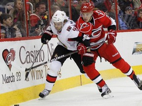 Senators forward Milan Michalek battles with Hurricanes forward Alexander Semin at PNC Arena in Raleigh, N.C., Feb. 1, 2013. (ELLEN OZIER/Reuters)