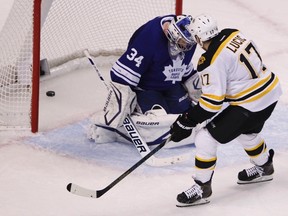 Bruins forward Milan Lucic scores a goal on Maple Leafs goaltender James Reimer on Monday night in Boston. (Reuters)