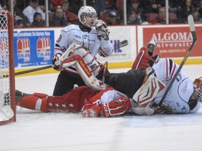 Owen Sound Attack goaltender Jordan Binnington rests on top of Sault Ste. Marie Greyhounds defenceman Colin Miller while Attack forward Artur Gavrus keeps his eye on the play during Game 3 of the team’s Ontario Hockey League playoff series Monday night in Sault Ste. Marie. The Greyhounds edged the Attack 5-3.