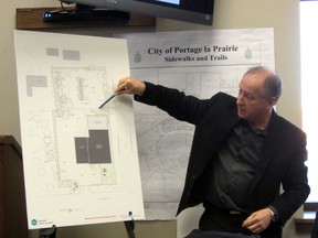 David J. Kressock, principal architect at LM Architectural Group, explains the proposed expansion of the MPI lot on Saskatchewan Ave. West. Area residents will be meeting with the city on Wednesday night to explain their grievances and then hopefully resolve any issues they might have with the Crown corporation and allow the project to move forward. (ROBIN DUDGEON/THE DAILY GRAPHIC/QMI AGENCY)