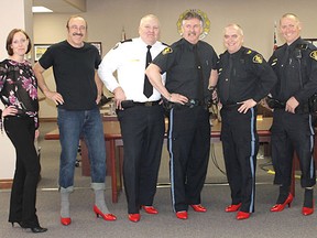 Women's House Serving Bruce and Grey's Tiffany Love stands with the men who braved the red high heels for the launch of the "Walk A Mile In Her Shoes" March 20 at the Kincardine Municipal Administration Centre. The event is June 9 in Owen Sound. L-R: Municipality of Kincardine foreman Brian Kelly, South Bruce OPP Detachment Commander/Inspector Scott Smith, provincial constables Gary Yost, John LeBlanc, Kevin Martin and staff sergeant Dana Earley.