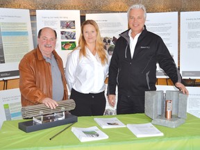 Mike Krizanc - NWMO communications manager, Melissa Mayhew - a social researcher with the NWMO and Norman Sandberg - area relationship manager were attending the organization’s open houses in Elliot Lake and across the North Shore. Krizanc has his hand on a replica of the nuclear fuel bundle. 
Photo by KEVIN McSHEFFREY/THE STANDARD/QMI AGENCY