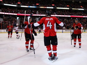 Ottawa Senators' Chris Phillips (4) celebrates his goal with Peter Regin (13), left, Mika Zibanejad (93), second from left, and Mike Lundin (10), right, while playing the New Jersey Devils during the first period of NHL hockey action at Scotiabank Place Monday Mar. 25, 2013. 
Darren Brown/Ottawa Sun/QMI Agency