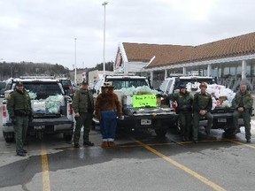 Local Ministry of Natural Resources aggregate and conservation officers are seen here with truck loads of non-perishable food items collected this past weekend to be donated to the Helping Hand Food Bank in Espanola.  Photo supplied.