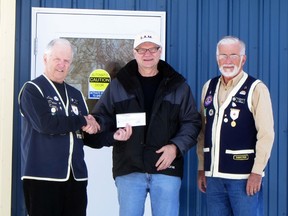Dave King and Al Morris of the Portage Lions Club present a cheque for $2,500 to Tom Wishart of S.A.M. Inc., Tuesday. The funds will be used to help purchase items for the client lunch program such as cooking utensils and furniture  for the new lunch room.  (ROBIN DUDGEON/THE GRAPHIC/QMI AGENCY)
