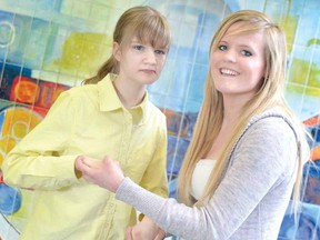 Stratford Northwestern student Abby Congram, at left, who has Rett syndrome, is shown Tuesday with Northwestern schoolmate Alicia Martin, who is organizing a fundraiser for the Ontario Rett Syndrome Association. (SCOTT WISHART, The Beacon Herald)