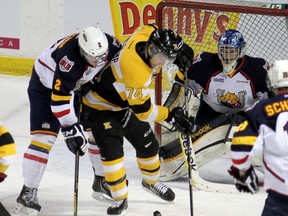 Kingston Frontenacs’ Luke Hietkamp can’t find the puck while being checked by Barrie Colts’ Jake Dotchin as goalie Mathias Niederberger looks on during Ontario Hockey League playoff action at the K-Rock Centre on Monday night. (Ian MacAlpine/The Whig-Standard)