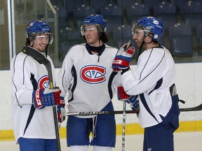 Members of the Kingston Voyageurs’ third line, from left, Scott Mossman, Brandon O'Quinn and Frankie Vilardi, share a laugh at practice Tuesday. The trio played a key role in the Voyageurs’ five-game series win over the Cobourg Cougars in Ontario Junior Hockey League playoff action. (Ian MacAlpine/The Whig-Standard)
