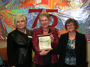 Carol Downing of the Peace Library System (left) presented a plaque Fairview Library’s 75th anniversary to Theresa Hrab, Fairview Library Board chair (centre) and Fairview’s head librarian Chris Burkholder (right).