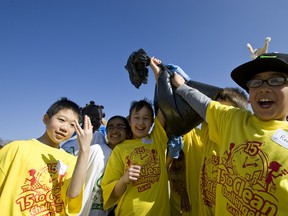 Students at Hillview School in Edmonton, Alberta, cleaned up garbage around their building on April 19, 2012 while taking part in the launch of Capital City Clean Up's 15-to-Clean Challenge. File Photo QMI Agency.