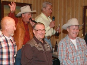 Studs up for auction for YARDWORK. From left, Jon Ouellette, Al Andrews, Cees VandenEnden, Bill Morison (Auctioneer from Bill Morison Auctioneers), Larry Mizera, Dan Butler (MC from 96.5 Radio in Olds), Lee Bolster (Owner of the Water Valley Saloon that hosted the event) and Kris Lashmore at the annual Water Valley Stud Auction on Mar. 22.