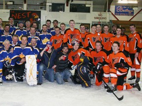 The Kings and Flyers players pose together for a photo after their game Mar. 22.