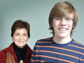 Joined by voice teacher Barbara Collier, Stratford's Callum Hutchinson, 15, holds the gold medal he won for earning top marks provincially in Grade 8 voice exams. (SCOTT WISHART The Beacon Herald)