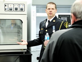 Chatham-Kent OPP Const. Darren Soucie, left, explains how officers can develop fingerprints through a number of different processes at the new OPP Forensic Identification lab in Chatham, On. Wednesday March 27 2013. DIANA MARTIN/ THE CHATHAM DAILY NEWS/ QMI AGENCY