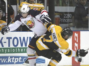 Barrie’s Devon Rymarchuk and  Kingston’s Ryan Hanes collide against the boards during Wednesday night’s Ontario Hockey League playoff game at the K-Rock Centre. (Michael Lea/The Whig-Standard)
