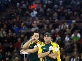 E.J. Harnden (left) stands beside his brother, Ryan, during this year's Tim Hortons Brier