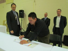 Chief Chris Plain takes part in a ceremonial signing ceremoney held Thursday at Aamjiwnaang First Nation to mark its partnership with Bkejwanong First Nation at Walpole Island in a wind farm Northland Power is seeking provincial approval to build near Grand Bend. The two First Nations will own 50% of the up to 48-turbine Grand Bend Wind Farm Project. (PAUL MORDEN, The Observer)