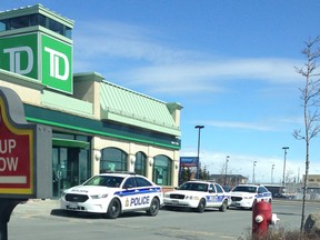 Ottawa police cruisers sit outside the Barrhaven TD Bank branch after a robbery Thursday morning. It was one of two banks hit by armed robbers within an hour. (Chrystal Brown Submitted image)