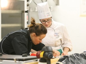 Sophie Maille, 19, watches Jessica Sanabria work on a moulding technique in preparation of the Callebaut Canadian Intercollegiate Chocolate Competition at Humber College in Hamilton next month. Maille is a second-year Canadore College culinary student.