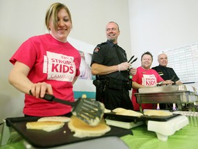 YMCA North Bay board member Nicole Bamford, North Bay Police Service Sgt. Jim Kilroy, YMCA member sales and service rep Sean Bradette and Ontario Provincial Police Sgt. Carlo Berardi serve up breakfast Thursday morning to mark the end of the annual YMCA Strong Kids Campaign. (MARIA CALABRESE The Nugget)