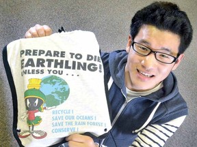 Stratford Central student Shoma Oura shows one of the TBags that are locally made from recycled shirts and being sold for $10. (SCOTT WISHART, The Beacon Herald)