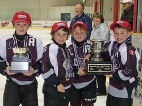 Tillsonburg Ward's Automotive novices are presented the OMHA BB championship hardware Sunday in Strathroy. Tillsonburg swept the six-point series with an 8-7 win. From left are captains Nolan McCrossin, Brandon Balazs, Hayden McLean and Beau Jelsma. CONTRIBUTED PHOTO