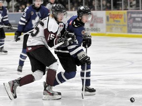 London Nationals Derek Todosichuk keeps the puck moving down the ice despite pressure from Chatham Maroon Michael Verboom during the first game of the finals at Memorial Arena in Chatham. The Nationals won 4-2. DIANA MARTIN/ THE CHATHAM DAILY NEWS/ QMI AGENCY