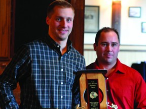 Brockville Braves defenceman Kevin Kirisits accepts the Donny Wallace Award from head coach and general manager Jason Hawkins at the team's annual end-of-season awards banquet. (STEVE PETTIBONE The Recorder and Times)