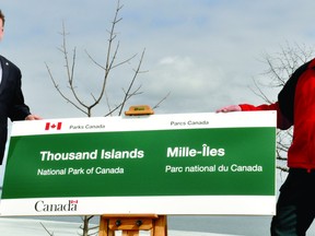 Leeds-Grenville MP Gord Brown, left, and Thousand Islands National Park superintendent Jeff Leggo unveil a sign on Thursday at Mallorytown Landing with the new name of the 109-year-old site, which was known until Wednesday as St. Lawrence Islands National Park. (NICK GARDINER/Recorder and Times)