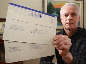 Michael Gvildys holds up two tax return envelopes addressed to different processing centres he picked up at separate locations in Owen Sound.