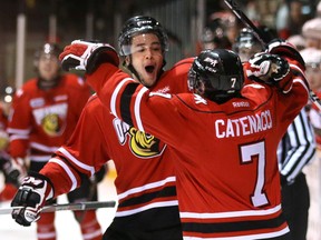 Owen Sound Attacks Steven Janes, left, and teammate Daniel Catenacci celebrate Catenacci's 2nd goal against the Sault Ste. Marie Greyhounds during first period action in Owen Sound Friday night.