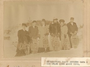 A snowshoeing party resrts between Wawa and the Helen Mine, circa 1910.