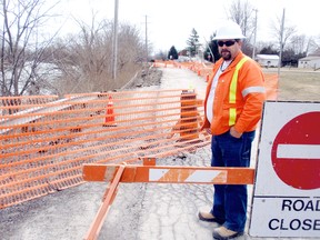 Glenn Harding, road supervisor for Chatham Township, inspects a section of Glasgow Line in Tupperville, Ont. Thursday, March 28, 2013, which is slipping into the Sydenham River as a result of erosion. The roadway has been fenced off to traffic between Burns Street and Tupperville Line, just east of the bridge in the small rural community in northeast Cahtham-Kent. Harding the roadway will eventually be repaired. (BOB BOUGHNER/ THE CHATHAM DAILY NEWS/ QMI AGENCY)
