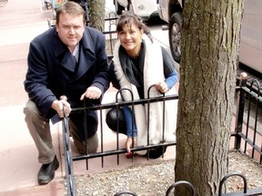 Andrew Thiel, chair of the Historic Downtown Chatham BIA and Sherry Molema, a board member, pose Wednesday, March 27, 2013 with one of the more than 90 iron rod tree surrounds along King Street in downtown Chatham, On. that will be removed this week following complaints from motorists that they bang their car doors on them and because they are a nuisance when it comes to snow removal. The surrounds are available for purchase for $40 each. (BOB BOUGHNER/ THE CHATHAM DAILY NEWS/ QMI AGENCY)