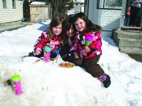 Neighbour Veda Fergusson, 6, joins Charleigh McMahon, 6 and sister Emme, 2 for a fair weather picnic on a snowbank outside the sister’s Lakeside home, Tuesday afternoon, Tuesday afternoon, March 26, 2013.
REG CLAYTON/KENORA DAILY MINER AND NEWS/QMI AGENCY