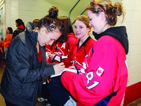 SEAN CHASE   Three-time Olympic Gold medallist Caroline Oullette signs autographs for some lucky fans after Team Canada's 8-0 victory over Sweden Saturday night at the Pembroke Memorial Centre.