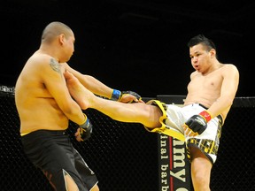 Dwight Chowace of Sturgeon Lake lands a kick to the shoulder of Cyril Glover of Saskatoon, Sask. at the inaugural XCessive Force Fighting Championships, at the TEC Centre on Saturday evening. Chowace forced Glover to submit  via arm triangle in the first round for his first professional victory in four MMA appearances. (TERRY FARRELL/DAILY HERALD-TRIBUNE)