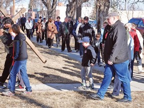 Father Ed Hospet, who came to Canada from Goa, India, about two years ago, lead the first stretch of the walking of the cross Good Friday. A few dozen people took part in the annual ceremony.