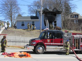 West Grey firefighters finish up after putting out a fire at a home on Garafraxa St. in Durham on Saturday.