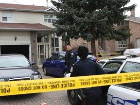 Toronto Police investigate the scene on Huntsmill Blvd., in the Warden and McNicoll Aves. area, Sunday March 31, 2013, after two bodies were found in the home and a third person was taken away in handcuffs. (Dave Thomas/Toronto Sun)